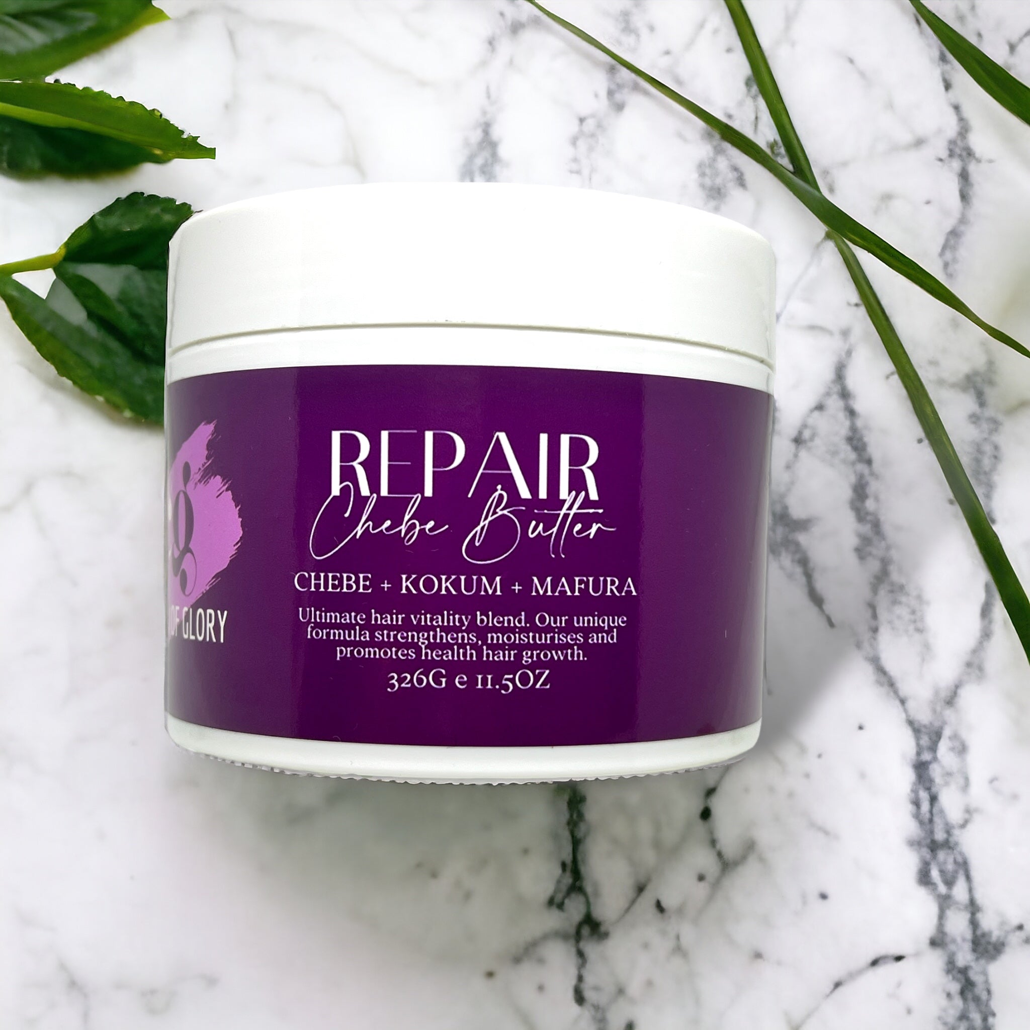A round white container with a purple label that reads "Repair Chebe Butter – Hair Growth & Nourishing Treatment" from Crown of Glory, placed on a marble surface. The label highlights "Chebe + Kokum + Mafura," emphasizing its benefits as a natural hair care solution for strength, moisture, and overall health. Weight: 326g (11.50 oz).